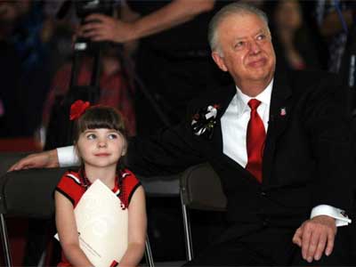 President John Peters and his granddaughter watch the video in his honor during Monday’s farewell reception.
