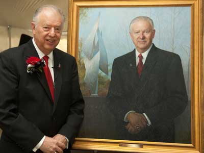 President Peters stands with his newly unveiled portrait.