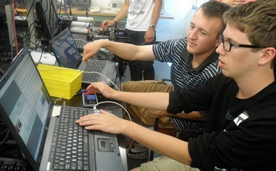 Neuqua Valley High School seniors Anders Nelson (left) and Jackson Davis (right) discuss readings recorded by their cosmic ray detector.