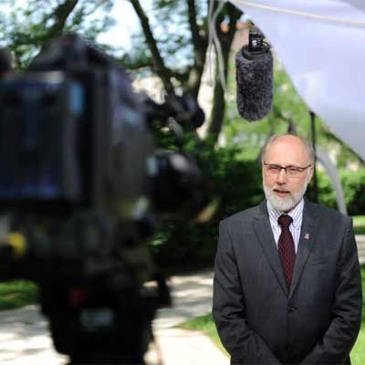 New NIU President Doug Baker films a video welcome message Thursday.