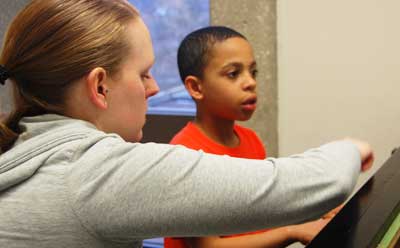 A young boy takes a piano lesson through the NIU Community School of the Arts.
