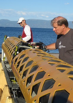 NIU geologists Reed Scherer (left) and Ross Powell insect the robotic submarine.