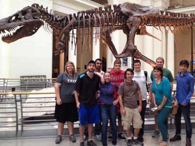 Students pose in front of the Field Museum’s Tyrannosaurus Rex, Sue.