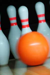 Photo of a bowling ball hitting pins