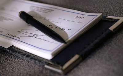Photo of checkbook and pen