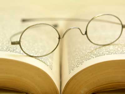 Photo of reading glasses on an open book