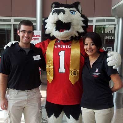 University Fellows Jarrett Wolske and Noemi Rodriguez join Victor E. Huskie, decked out in his Honors Program sash.