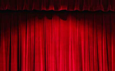 Photo of a red velvet curtain in a theater