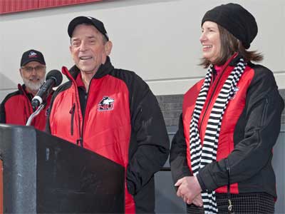 Kenneth and Ellen Chessick address the crowd gathered at the Yordon Family Huskie Pride Plaza, located on the east side of the Chessick Practice Center. 