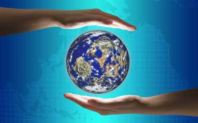 Image of hands framing the globe in front of a world map