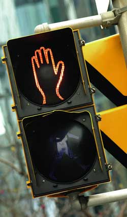 Photo of a red hand on a stoplight