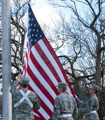 NIU ROTC members lower the flag at the 2012 Veterans Day service.
