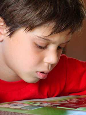 Photo of a boy reading a book