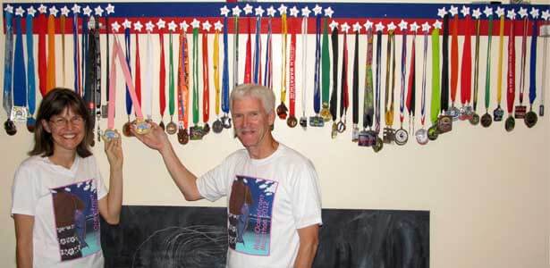 Karen and Carl show off their half-marathon medals from all 50 states.