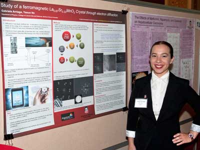 Gabriela Arriaga stands with her poster as the Summer Research Symposium.