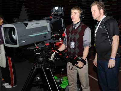DHS student Owen Smith operates the video camera under the supervision of NIU Media Services student worker Wesley Lynch.