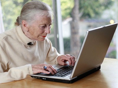 Photo of an elderly woman with a laptop