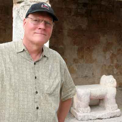 Professor Jeff Kowalski standing in front of the jaguar throne in the Lower Temple of the Warriors at Chichen Itza, Mexico.