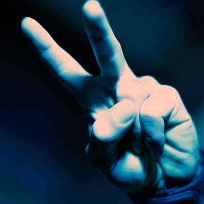 Photo of a hand with two fingers making the "peace" sign