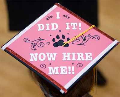 Photo of an NIU graduation cap: “I did it! Now hire me!”