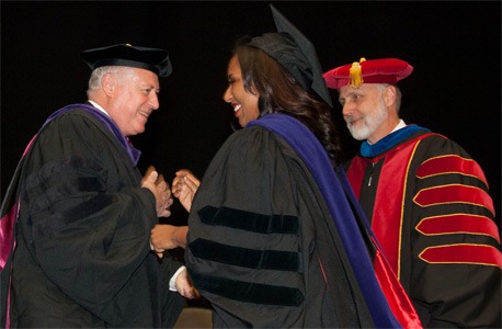 Gov. Pat Quinn and NIU President Doug Baker greet Illinois State Sen. Toi W. Hutchinson during the NIU College of Law commencement.