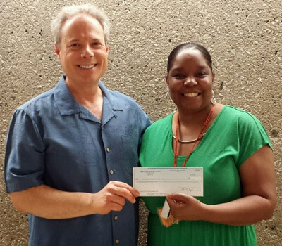 Dean Rich Holly receives the grant check from Latricia Dawkins, board member of the DeKalb County Community Foundation.