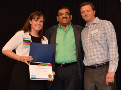 NIU’s Randi Napientek is congratulated by Mahendran Jawaharlal (center) and Sean Sullivan of EBI MAP-Works.