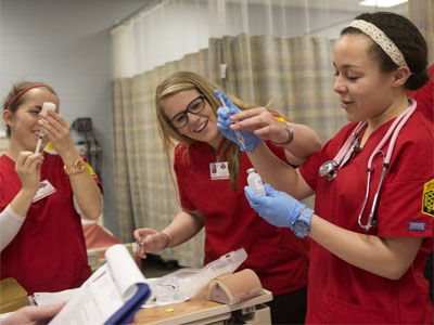Courtney Crutchfield (right) works in the nursing lab.