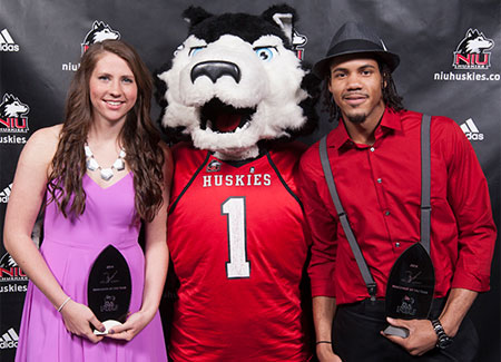 Student-athletes pose with Victor E. Huskie