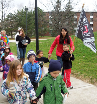 Young children crossing campus