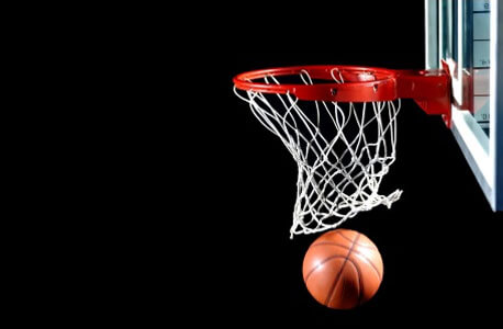 Photo of a basketball going through a hoop