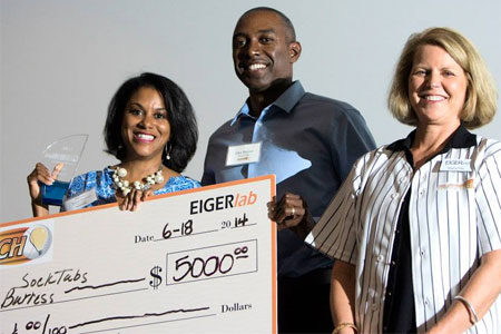 Tracie Burress, seen here with her husband, Glen, and EIGERlab’s Sherry Pritz, was awarded $5,000 and named the winner of the 2014 FastPitch competition for sockTABs.