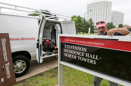 New campus signage is installed outside the North Towers of Stevenson Residence Hall.