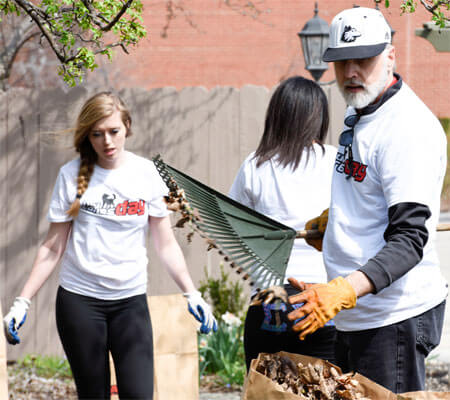 President Baker bags leaves during NIU Cares Day.