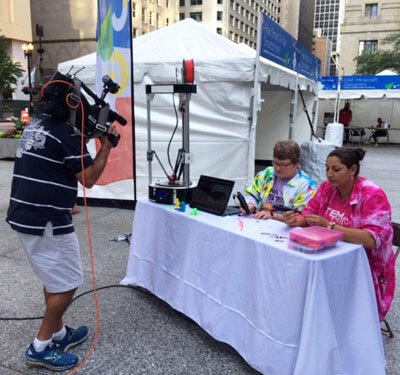 NIU’s Pettee Guerrero (right) and Pati Sievert made the TV news during Wednesday’s Google Geek Street Fair in Chicago.