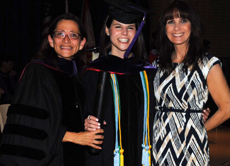 Former NIU Law Dean Jennifer Rosato Perea congratulates new grad Shaina Kalanges and Donna Sandacz, an NIU Law alumna and Shaina's mother.