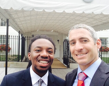 NIU student Randiss Hopkins and senior advisor to the Vice President and Special Assistant to the President Greg Schultz pose in front of an entrance to the White House on August 4.