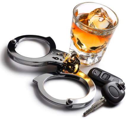 Photo of a glass of alcohol, car keys and handcuffs
