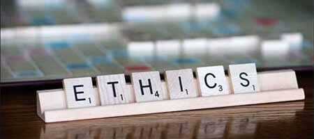 Scrabble letter spelling the word "ethics"