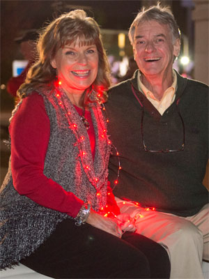 Sue Corrao and fellow 1965 Homecoming Court member Dennis Twitty help NIU ‘light the way’ during the nighttime parade.