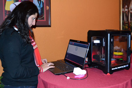 STEM Outreach Associate Pettee Guerrero demonstrates a MakerBot at a past presentation of The 3D Printing Revolution.