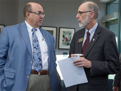 NIU President Doug Baker (right) chats with Dean L. Bartles, chief manufacturing officer of UI Labs and executive director of the Digital Manufacturing and Design Innovation Institute.