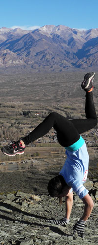 Student Danielle Dyra, happy to have reached the summit during a hike, pops a handstand.