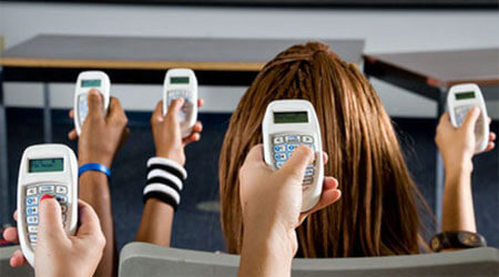 Photo of students holding clickers