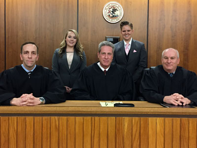 The Moot Court champion team of second-year law students (standing from left) Chelsea Selvey and Stephanie Wiggins argued before the distinguished bench of (seated from left): Winnebago County Public Defender Nick Zimmerman (’00); the Honorable Joseph G. McGraw (’85), Chief Judge of the 17th Judicial Circuit of Illinois; and the Honorable Timothy J. McCann (’88), Presiding Judge in the Kendall County (IL) Circuit Court.
