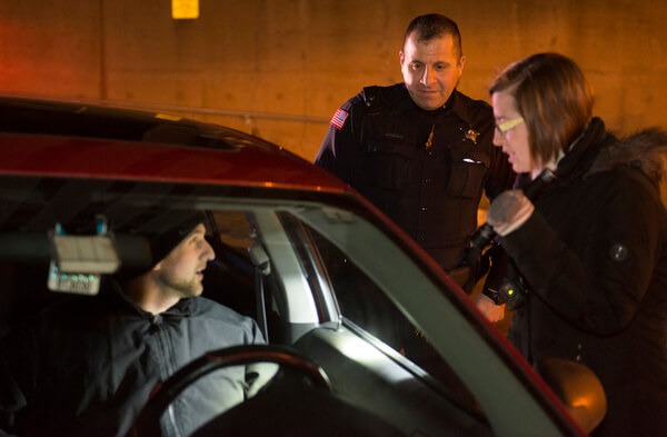 Director of Student Involvement and Leadership Development Jill Zambito learns what it's like to conduct a traffic stop with help from NIU Police Officer David Jadran during the 2016 Citizens Police Academy.